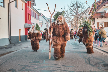 Three hairy wild men. Carnival party in southern Germany - Black Forest. Street Carnival in Southern Germany - Black Forest.