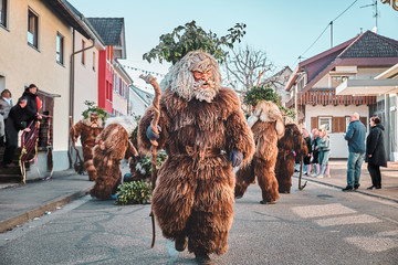 Haired wild man with branches on his head. Carnival party in southern Germany - Black Forest.