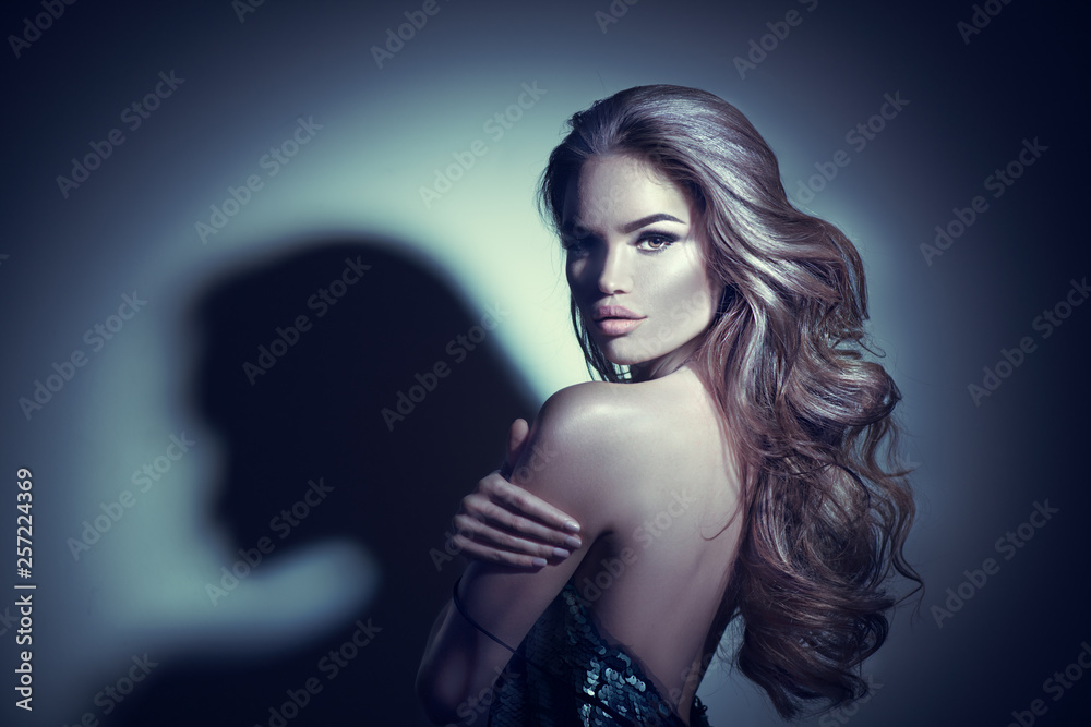 Wall mural sexy young woman portrait. seductive brunette girl posing in darkness. beauty glamour lady with long