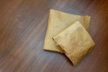 Two brown color paper bag. Walnut background and texture table. The concept of environmentally friendly packaging products. Copy space.