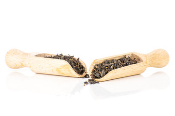 Lot of pieces of dry black tea earl grey with wooden scoop isolated on white background