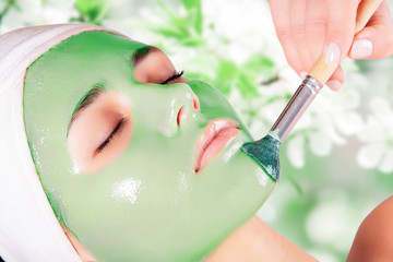Young beautiful woman with moistening seaweed facial mask at beauty salon. © Vladimir Sazonov