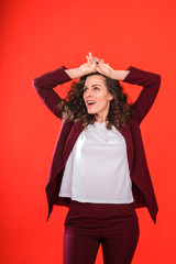 Portrait of beautiful woman on red background.