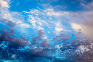 Fototapeta na wymiar Bright blue sky with gentle cumulus clouds. Pink vanilla heaven. Natural summer and spring background.