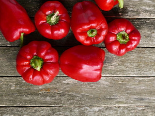 Red sweet pepper on old wooden background
