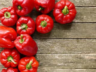 Red sweet pepper on old wooden background