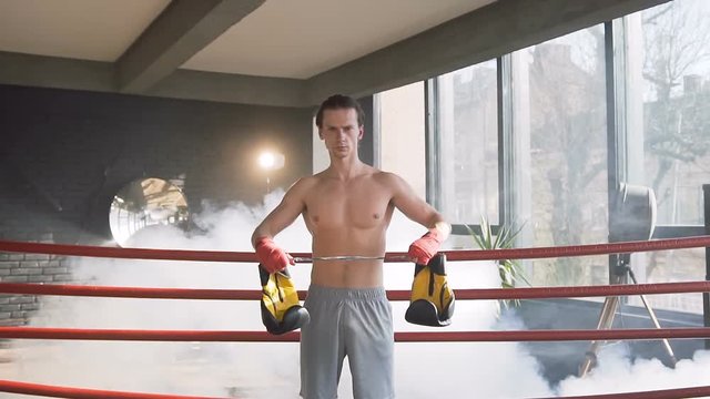 Attractive young male boxer in the gym.