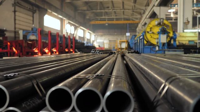 Metallic pipes on warehouse, rows of metal pipes on industrial warehouse. Industrial interior,