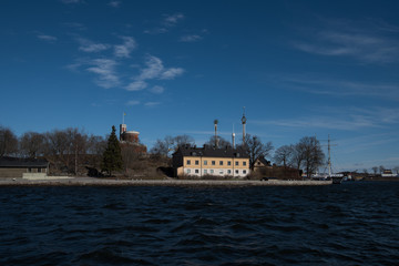 A sunny spring day in Stockholm, view over a pier with boats and birds at the city and old town