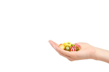 Hand with colored round candy, sugar lollipop