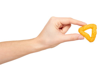 Hand with cheese puff sticks, crunchy corn snack, unhealthy food.