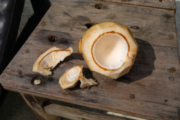 Open empty fresh coconut on wooden table background
