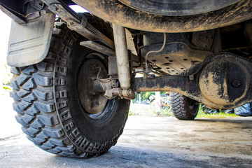 The off-road car or 4x4 car shows the suspension and shock-up system and the big tire for adventure driving © Hatori_Shisuka