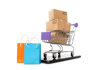 Paper boxes in a trolley with mobile phone on white background,Online shopping or ecommmerce concept