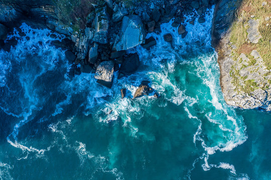 Detail of sea waves colors breaking in the coast of Lekeitio, Basque Country - drone view - drone view