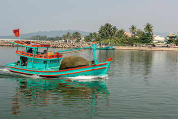 Fototapeta na wymiar Fishing boat in full speed to harbor in Duong Dong town at Phu Quoc Vietnam.