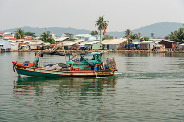 Fototapeta na wymiar Fishing boat going out to sea from Duong Dong harbor at Phu Quoc Vietnam.