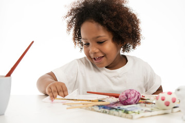 Celebrate Easter holidays, cute girls, happy young children with curly hair near colorful eggs, pencils, rabbits white color, isolated on a white background.