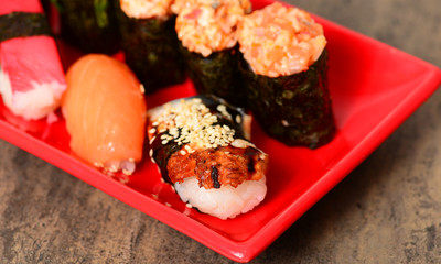 Tasty sushi on ceramic plate