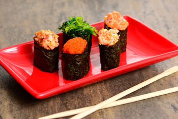 Chopsticks and rolls on table