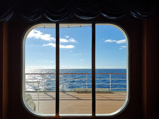 A view from the window of a cruise ship, showing the clear sky ocean.