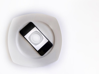  white plate and phone on white background