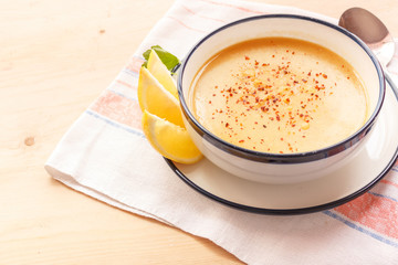 Traditional lentil soup in a white plate on a wooden table