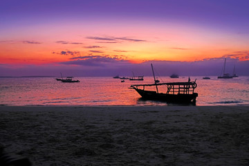 Ships against the background of a beautiful sunset on the ocean in Africa. Zanzibar Island, Tanzania