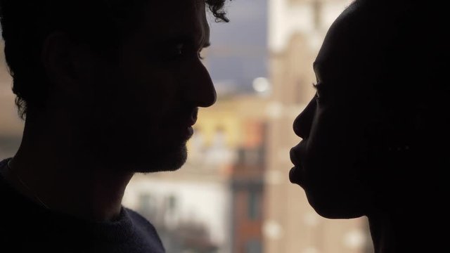 caucasian man and black woman silhouette kissing.Mixed couple,interracial love