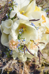Delicate wedding bridal bouquet of the opened white lyupan on the background of nature tree and moss. Wedding floristry, floristic composition, unusual unique bouquet