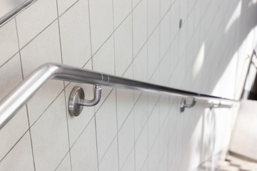 stainless steel handrail on ceramic wall.
