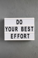'Do your best effort' words on lightbox over concrete background, top view. Overhead, from above. Flat lay.