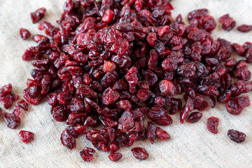 Dry organic cranberries on cloth, side view. Close-up.
