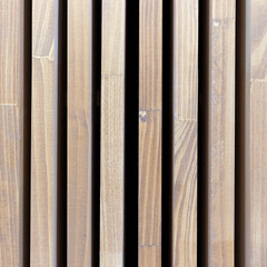 Texture wooden vertical stripes. Background natural tree with black stripes. Square size photo.