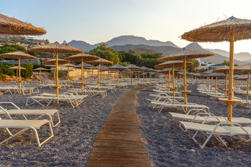 Fototapeta na wymiar Beach umbrellas from bamboo. One of the cleanest and most beautiful beaches in Crete.