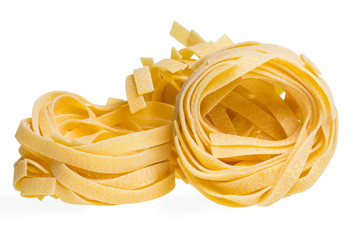 Raw yellow three tagliatelle or fettuccine pasta isolated on white background, focus stacking. Close-up macro DOF.