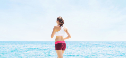 Young and sporty woman running outdoor. Fitness, sport, jogging and health care concept.