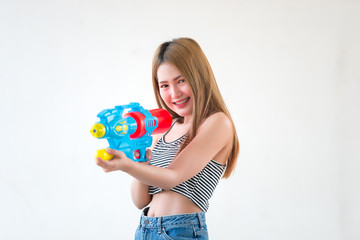 Asian sexy woman with gun water in hand on white background,Festival songkran day at thailand,The best of festival of thai,Land of  smile