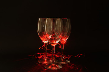 Glass wine glasses in red light