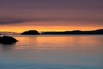 Stunningly beautiful sunsets of rocky beaches and mountains in beautiful British Columbia's Howe Sound on Bowen Island.