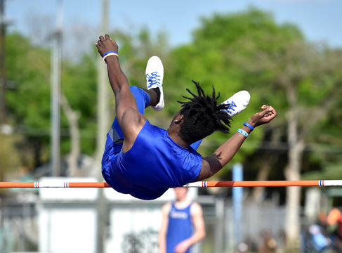 Young High School Boy Competing In The High Jump At A Track Meet