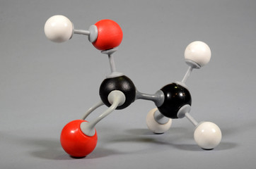 Molecule model of vinegar acid. White is hydrogen, black is carbon, red is oxygen.