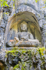 Fototapeta na wymiar Hangzhou Lingyin Temple embossed statue in rock. (Temple of the Soul's Retreat) One of the largest Buddhist temples in China