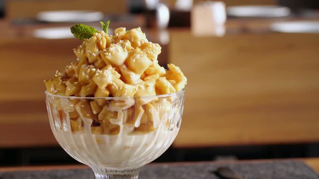 Oriental sweets chak-chak with honey and sesame seeds close up rotates