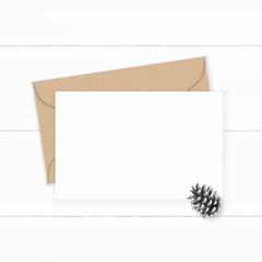 Flat lay top view elegant white composition letter kraft paper envelope pine cone on wooden background