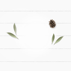 Flat lay top view elegant white composition paper botanic garden plant leaf flower pine cone on wooden background