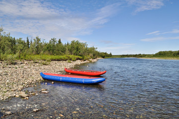  Two inflatable canoes on the shore of  North river.