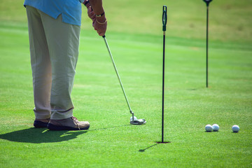 Fototapeta premium Man Playing Golf on Beautiful Sunny Green Golf Course. Sport and lifestyle concept