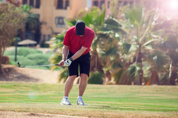 Man Playing Golf on Beautiful Sunny Green Golf Course. Sport and lifestyle concept