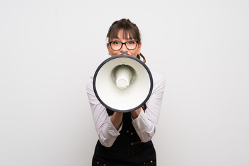 Young woman with apron shouting through a megaphone